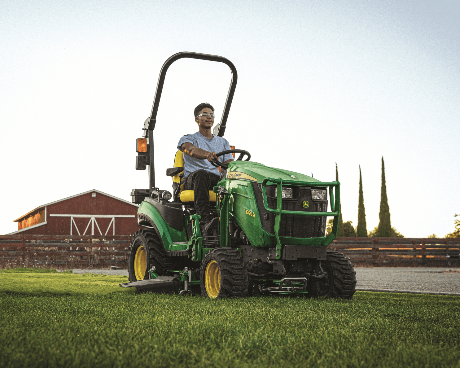 A John Deere 1025R tractor mows the grass on a property in Tennessee.