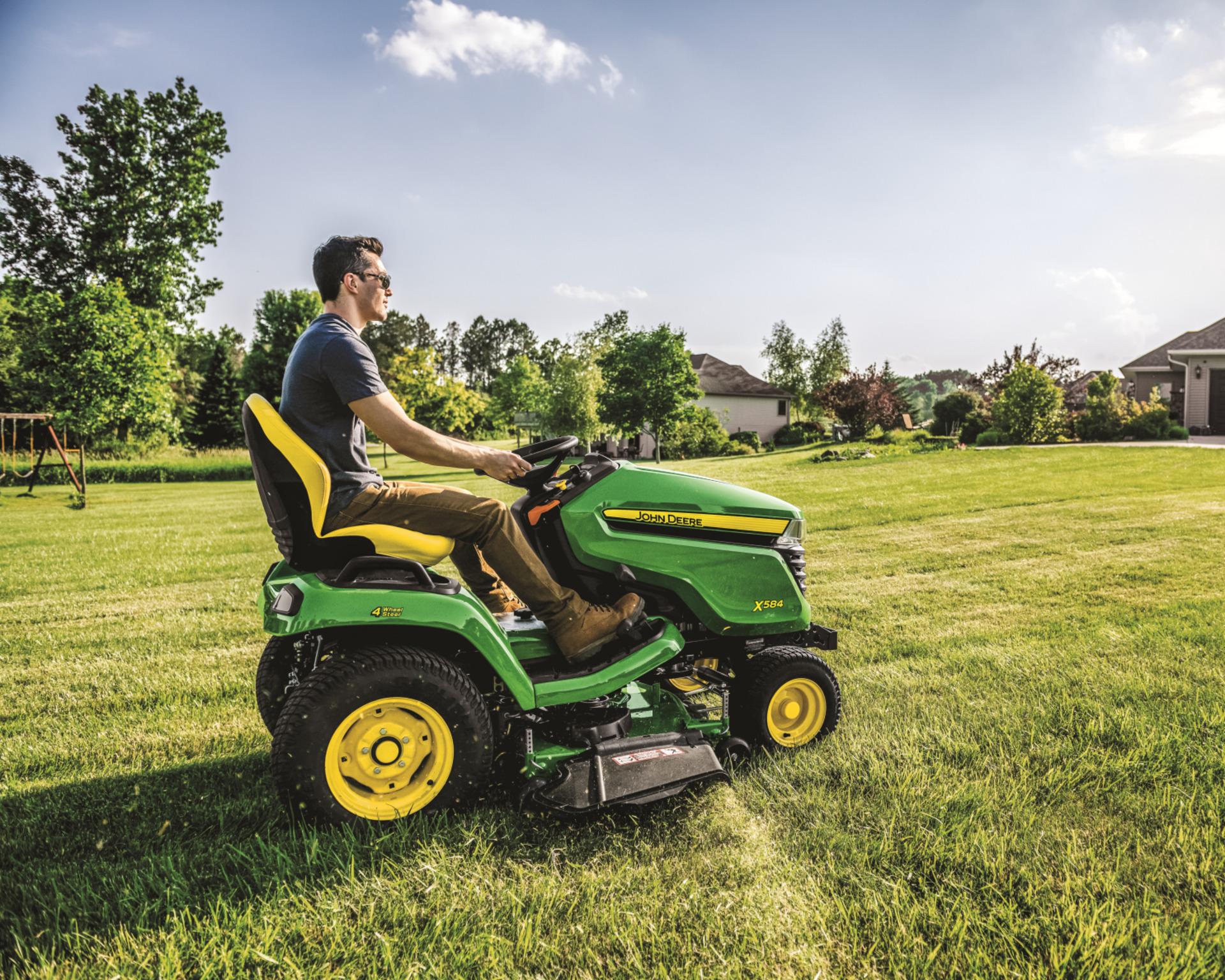 A man mowing a lawn to prepare for winter in Tennessee.