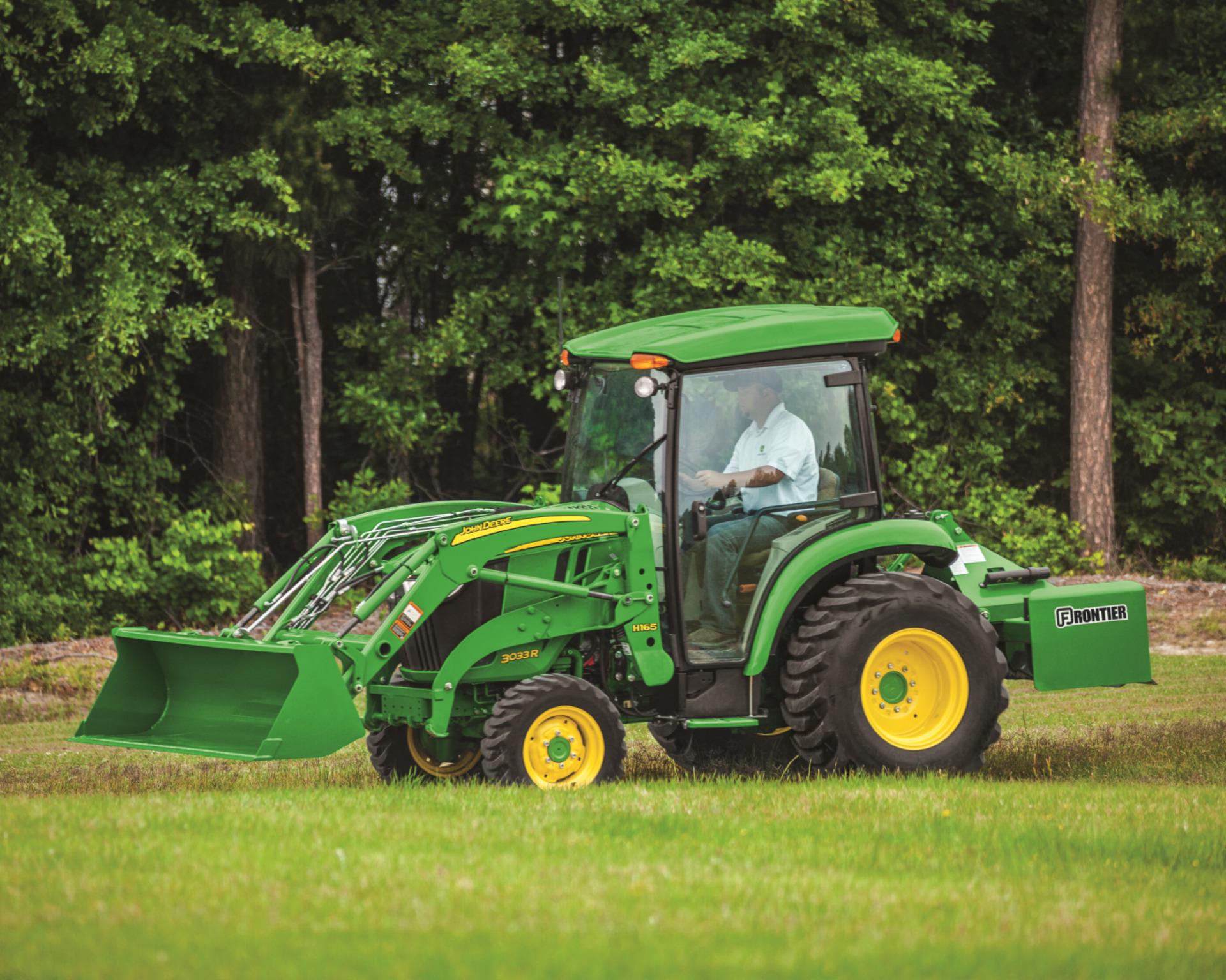 A John Deere 3033R compact utility tractor with cab.