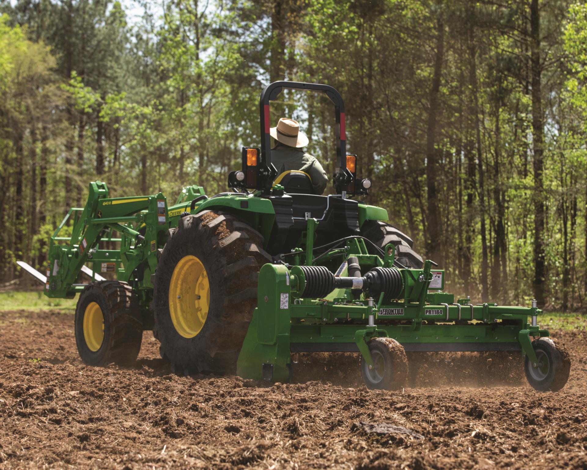 A John Deere 4066M tilling soil.