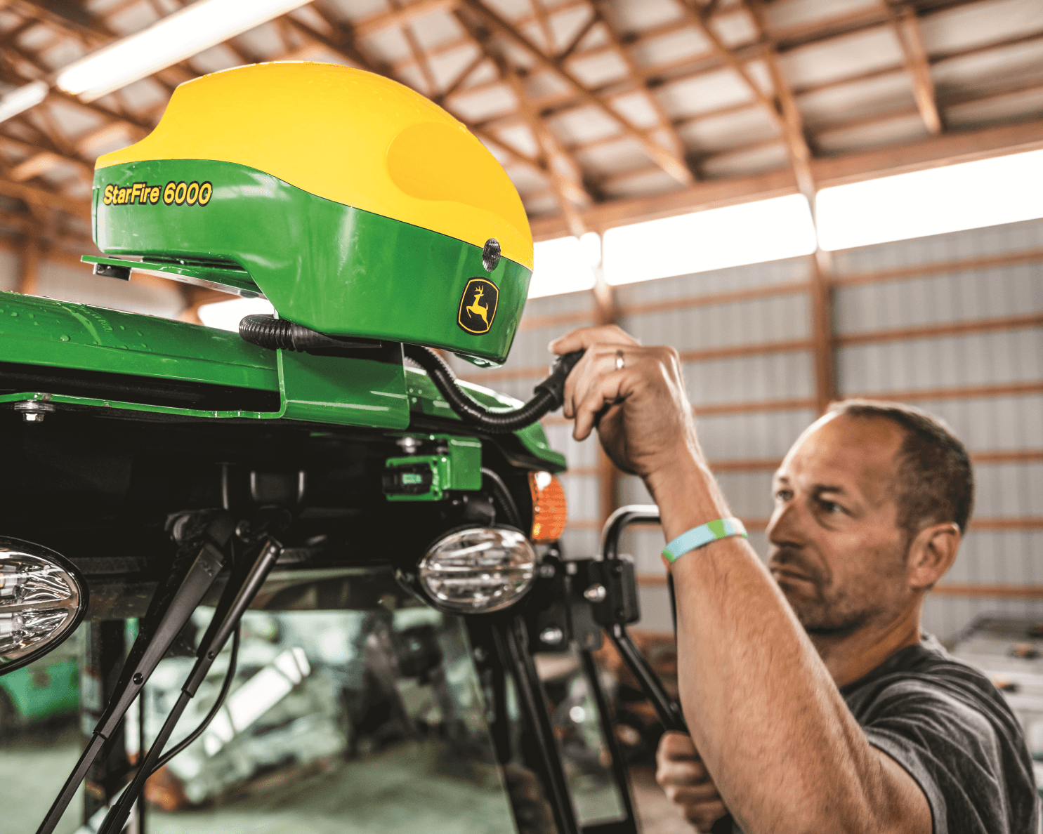 A worker checking out a John Deere StarFire receiver.