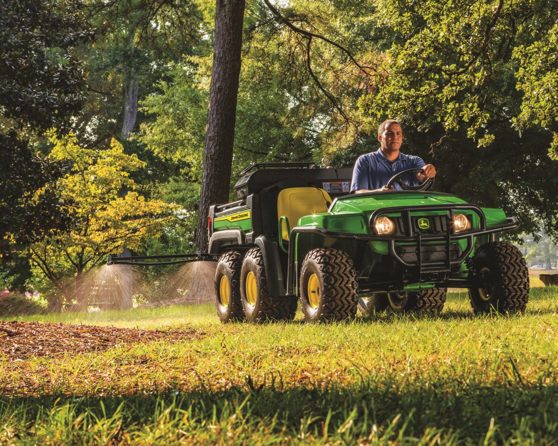 A John Deere Gator Diesel UTV driving through the woods.